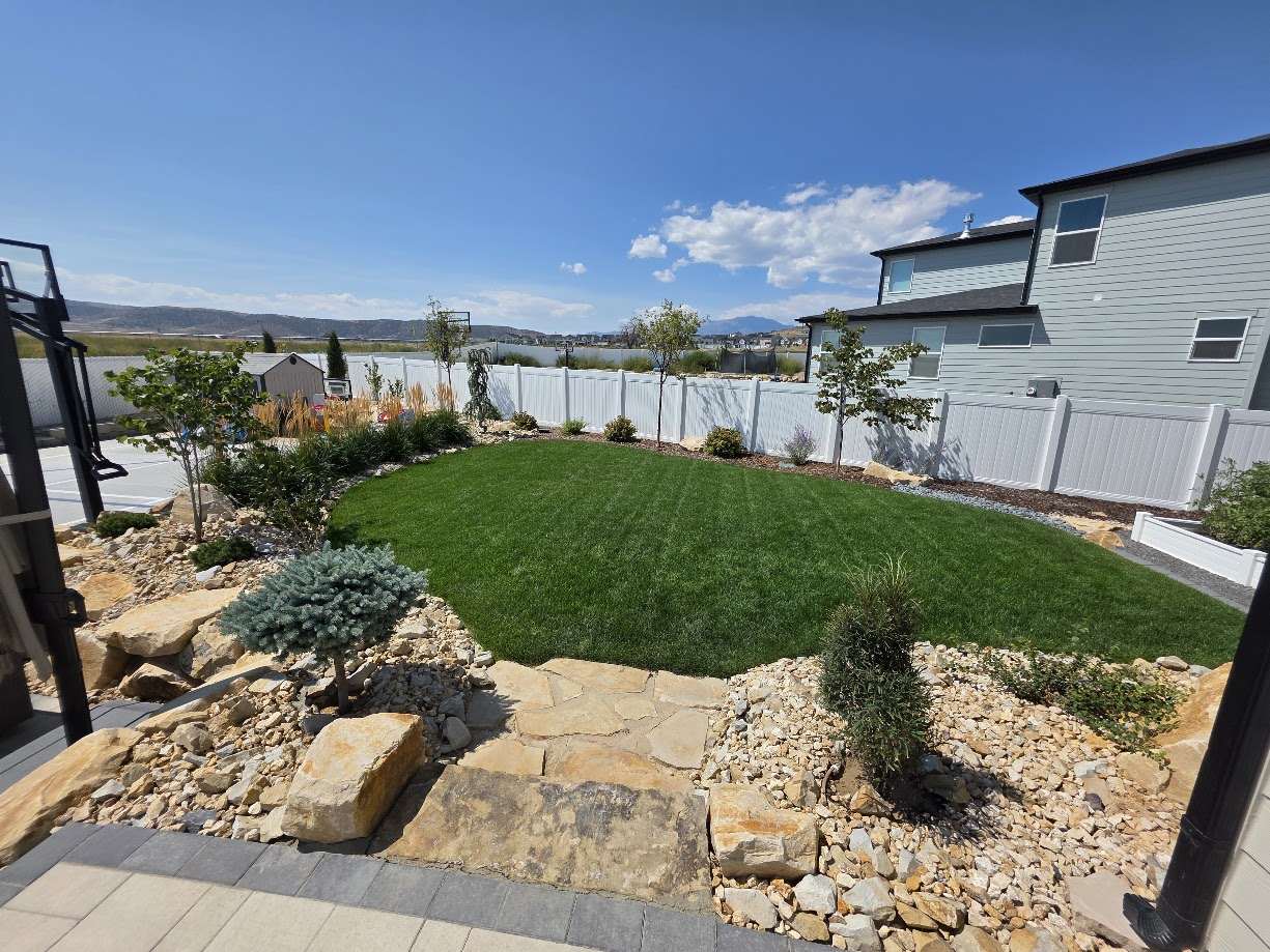 Luxury residential landscape with stone patio and mountain views